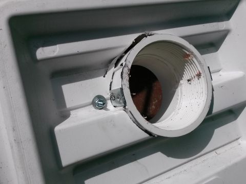 1996 Ford Bronco - A close-up view of a white plastic pipe with a metal bracket and bolt.