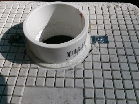 1996 Ford Bronco - A white plastic pipe fitting is attached to a textured surface.