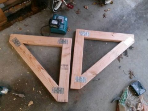 1996 Ford Bronco - Two triangular wooden frames are assembled with metal brackets on a concrete surface.