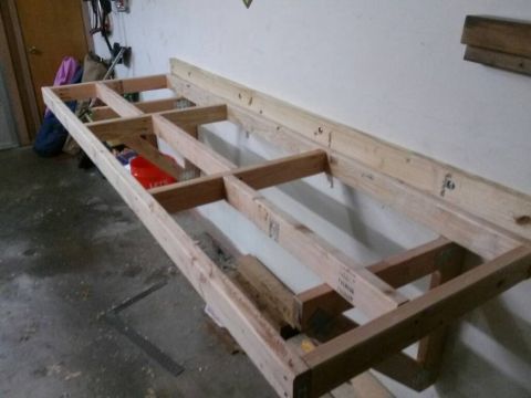 1996 Ford Bronco - A partially constructed wooden workbench frame is shown in a garage setting.