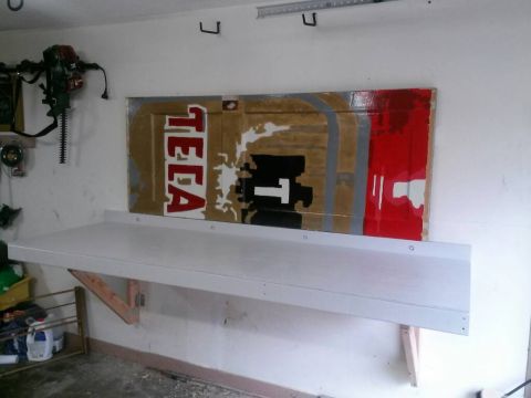 1996 Ford Bronco - Workbench installed in a garage with custom painted artwork displayed on the wall above it.
