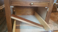 1975 Ford Ranchero - Close-up view of the wooden drawer slides and supports within a cabinet.