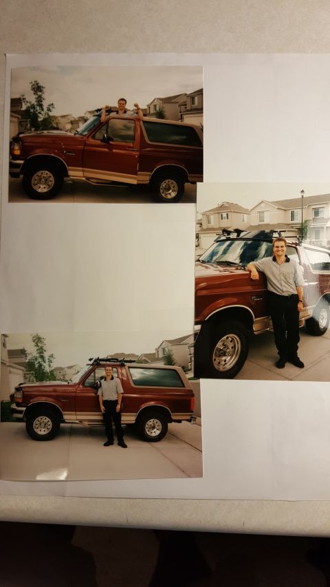 1996 Ford Bronco - A man poses with his red 1996 Ford Bronco, which has a roof rack and is parked in a driveway.