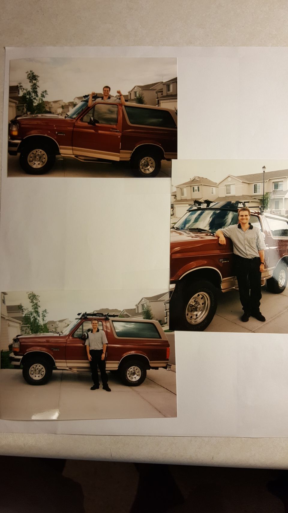 Red 1996 Ford Bronco with a roof rack and a man standing next to it
