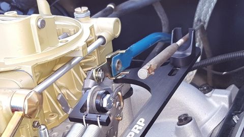 1978 Ford Bronco - Close-up of a carburetor and its linkage system, with visible text from SuperMotors.net.