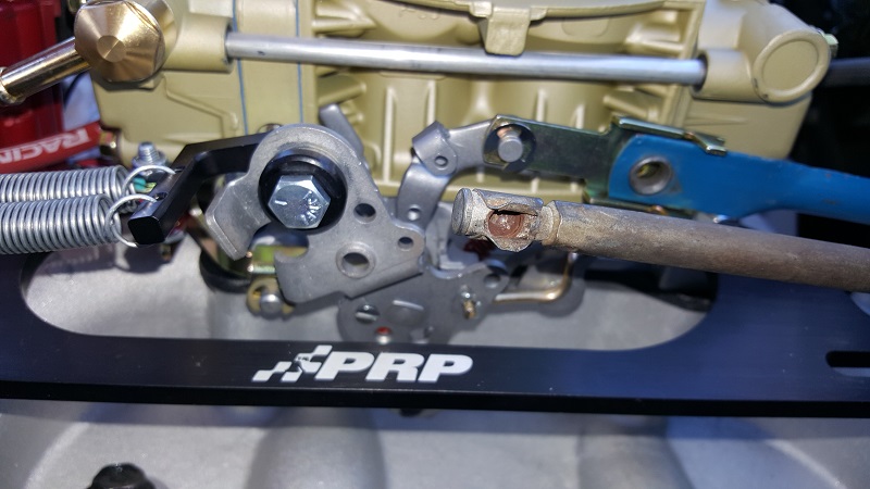 Close-up of carburetor linkage with PRP branding and Supermotors logo
