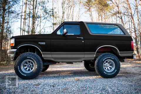 1995 Ford Bronco - This lifted 1995 Ford Bronco features a two-tone black and grey paint scheme, its off-road capabilities.