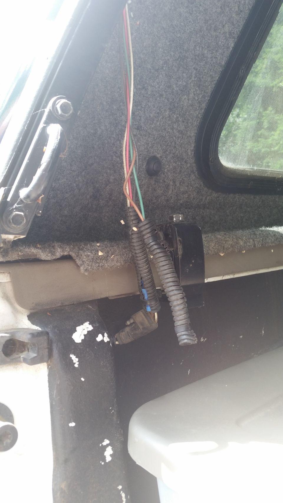 exposed wiring harness with multiple colored wires and a black connector