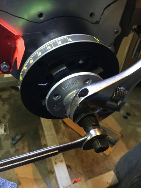 1978 Ford Bronco - A wrench is used to turn the engine crankshaft pulley which has timing marks.