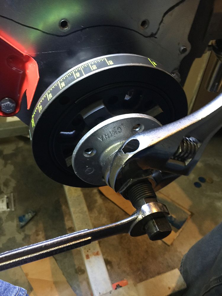 Crankshaft pulley with timing marks and a wrench on the bolt
