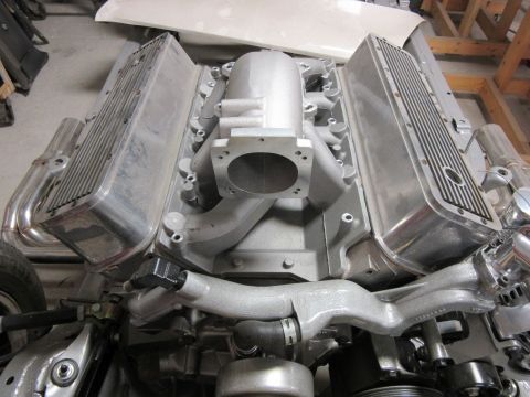 Aluminum V8 engine with chrome exhaust headers and intake manifold