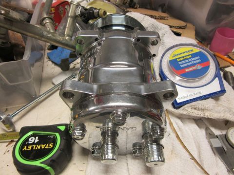 Chrome Sanden air conditioning compressor with mounting brackets and fittings. Angle finder and tape measure n