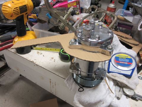 Chrome distributor cap and engine parts on a workbench with tools