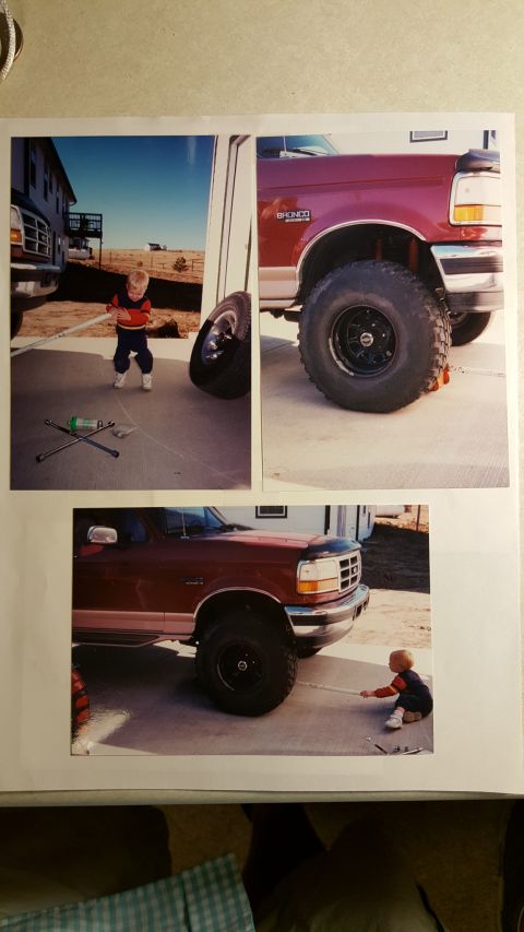 1996 Ford Bronco - Child plays near a 1996 Ford Bronco, which appears to be undergoing maintenance.