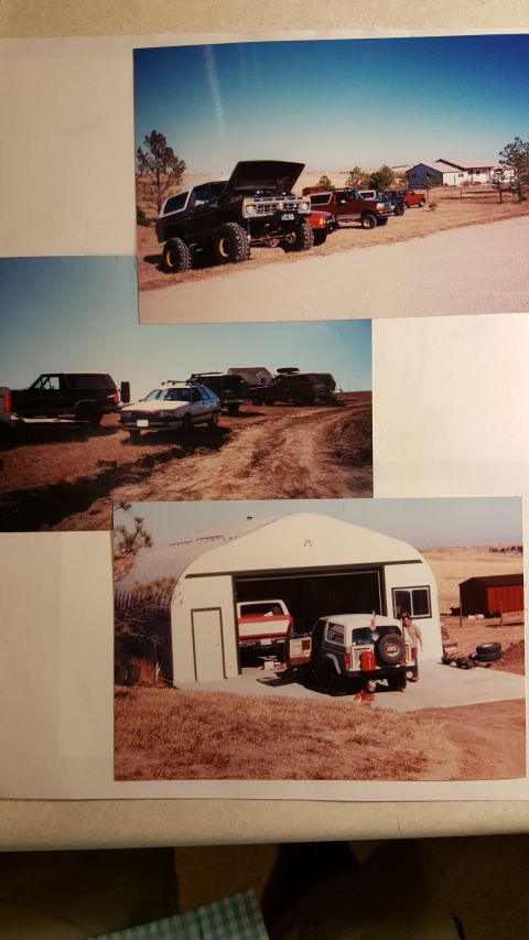 1996 Ford Bronco - Several vehicles are parked outside a rural property under a clear blue sky.
