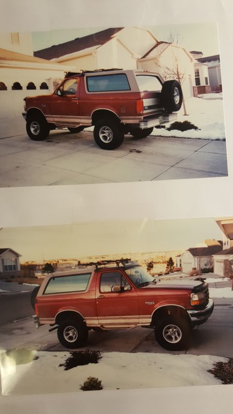 1996 Ford Bronco - Red 1996 Ford Bronco with a roof rack and spare tire mounted on the back.