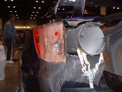 1999 Ford Crown Victoria - Custom car rear end modification with a large exhaust pipe and exposed components.