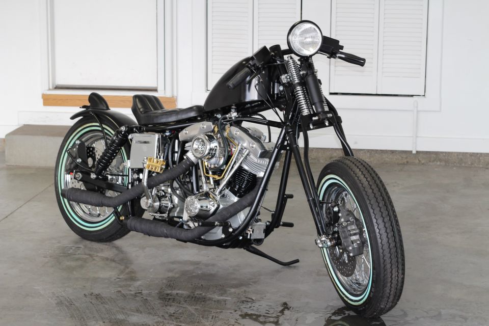 Custom black motorcycle with chrome engine details and whitewall tires