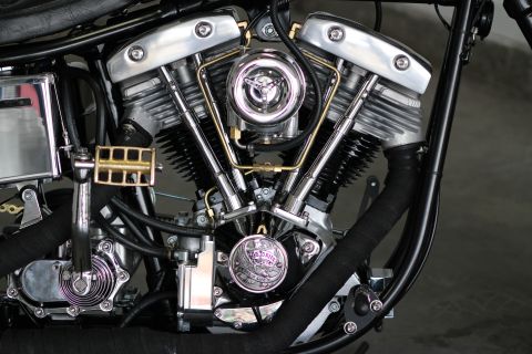 1975 Harley-Davidson FXRT Sport Glide - A detailed view of a motorcycle's V-twin engine, its mechanical components and polished finishes.