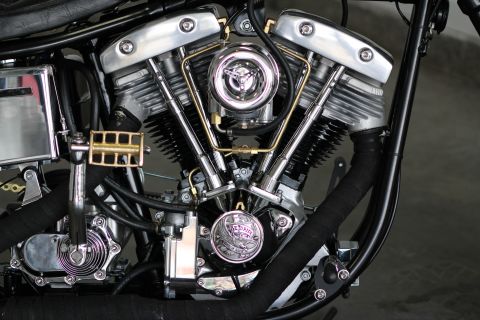 1975 Harley-Davidson FXRT Sport Glide - Close-up view of a motorcycle's V-twin engine, highlighting its intricate mechanical details and chrome finish.