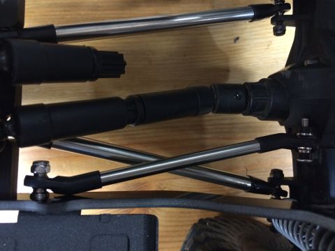 1989 Ford Bronco - This image shows a close-up view of suspension components, including metal rods and black drive shafts, not a 1989 Ford Bronco.