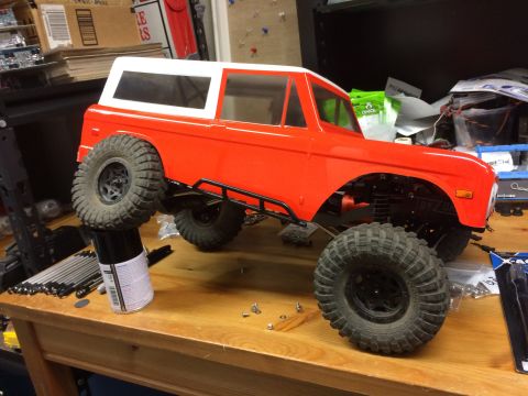 1989 Ford Bronco - An unpainted RC car body, resembling a classic SUV, is assembled on a wooden table.
