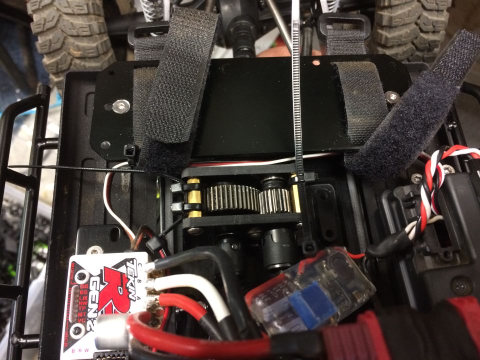 Close-up of RC car chassis showing gears, wiring, and a Tekin Gen2 ESC