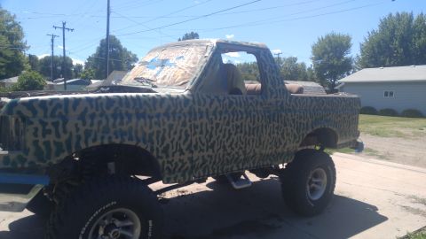 1991 Ford Bronco - This lifted 1991 Ford Bronco is painted in camouflage and sits on a driveway.