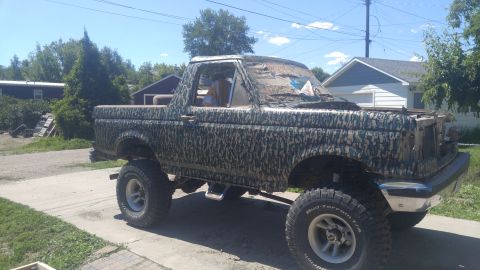 1991 Ford Bronco - This lifted Ford Bronco is covered in camouflage wrap and appears to be from the early 1990s.