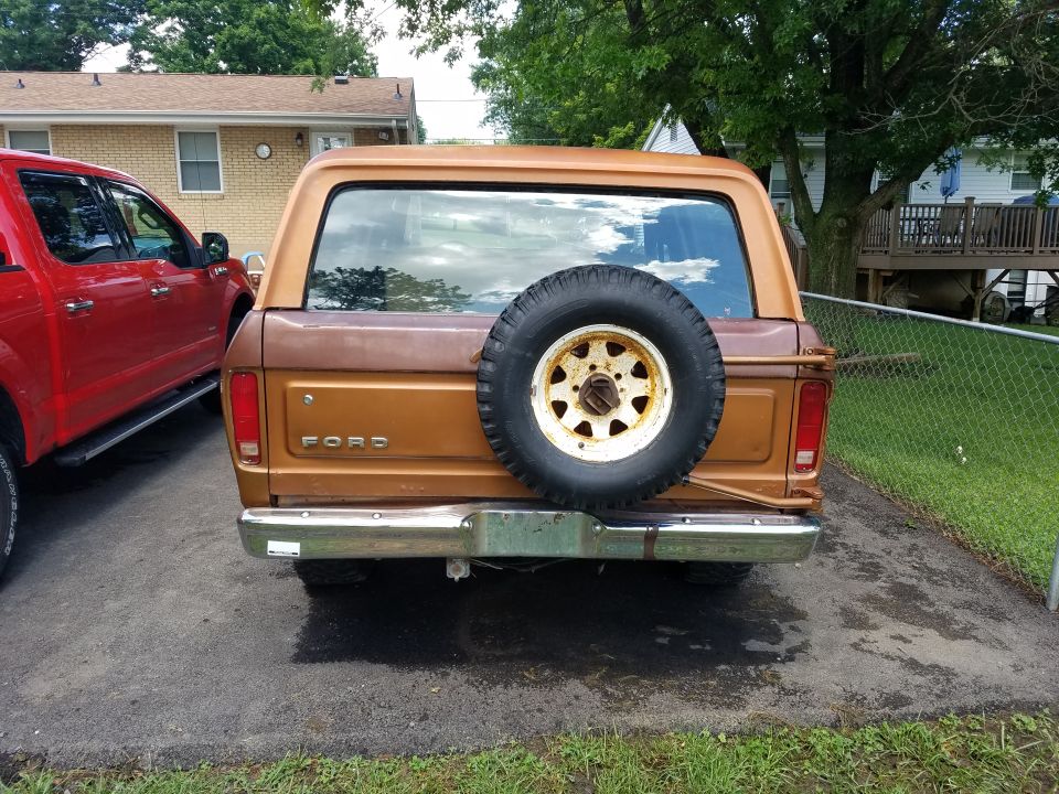 Brown 1978 Ford Bronco rear view with spare tire mounted on tailgate
