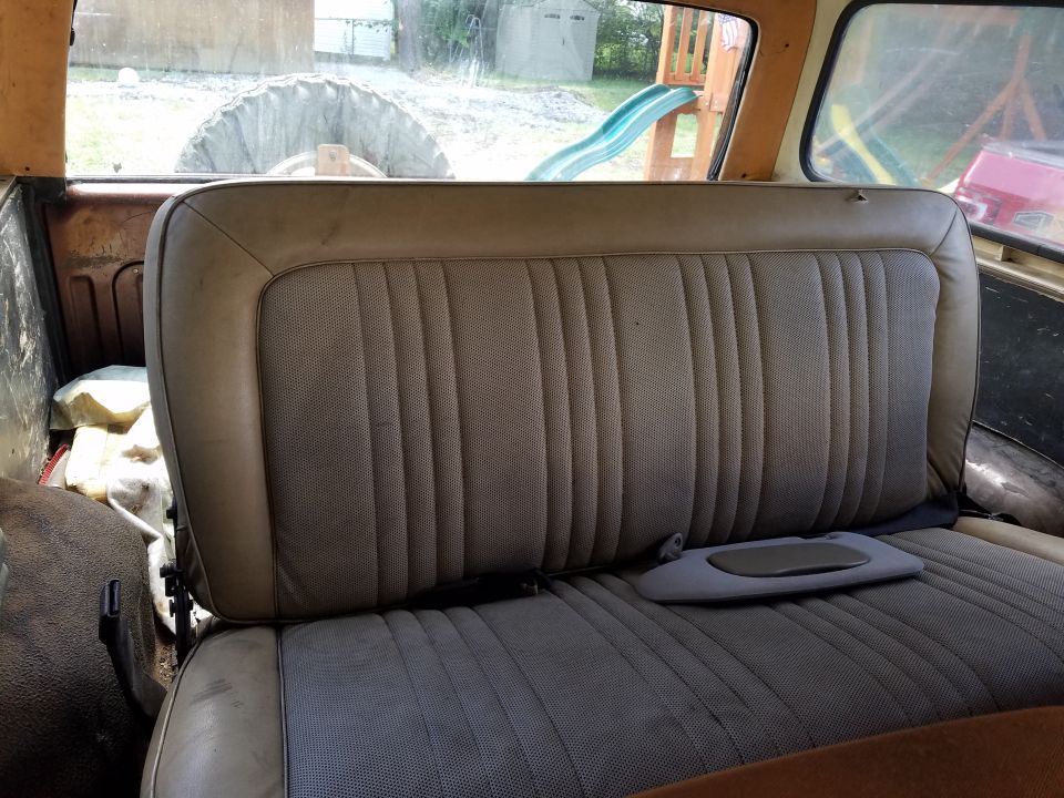 Interior rear seat and spare tire visible through the back window