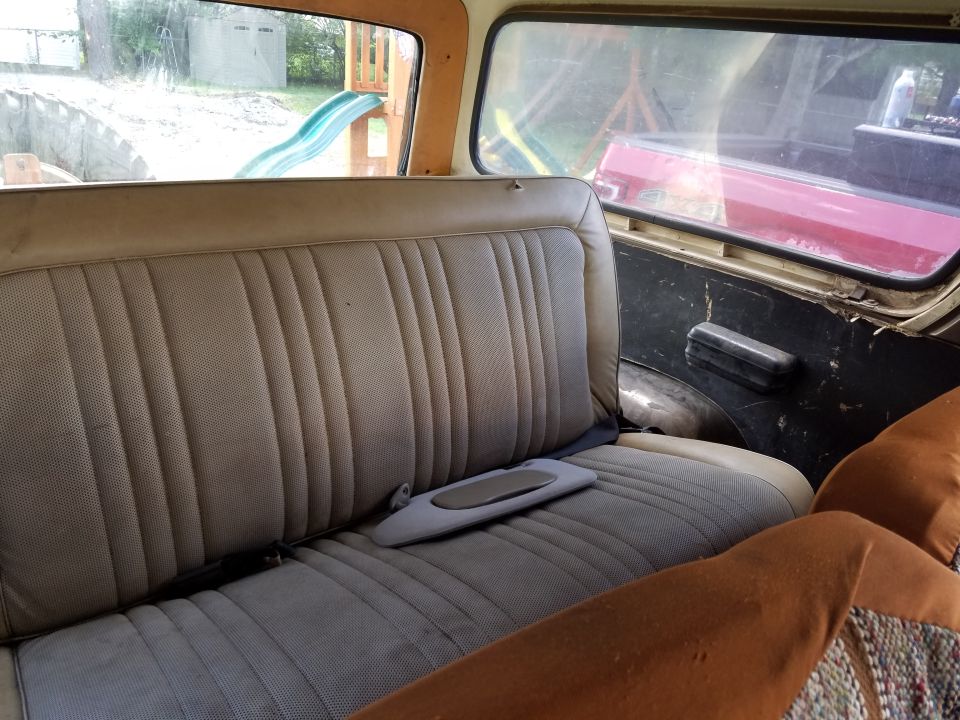 1979 Ford Bronco interior showing rear bench seat and door panel