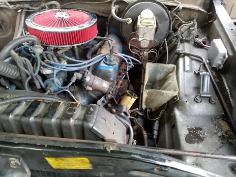 1979 Ford Bronco - Close-up view of a vehicle's engine bay, showing various components and wiring.