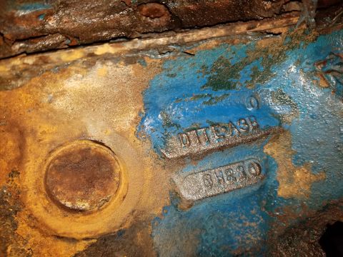 1979 Ford Bronco - Engine block casting with stamped part numbers, showing rust and blue paint.