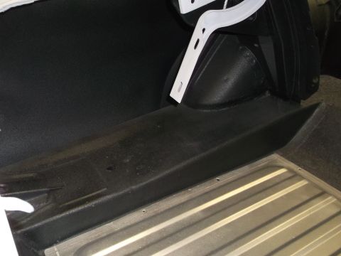 1967 Ford Mustang - Close-up view of the trunk area of a vehicle, showing the floor and side paneling.