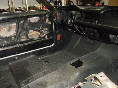 1967 Ford Mustang - The interior of a classic car is shown during a restoration project, with most components removed.