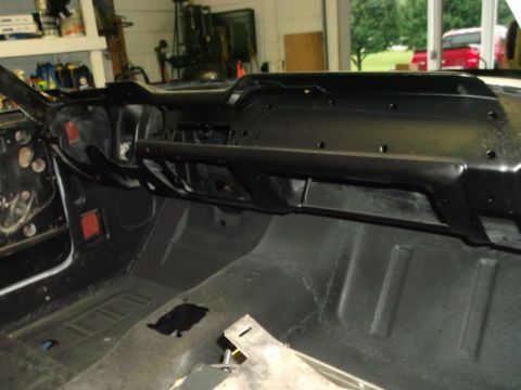1967 Ford Mustang - The interior of a 1967 Ford Mustang shows a disassembled dashboard and floor panels, indicating restoration work.