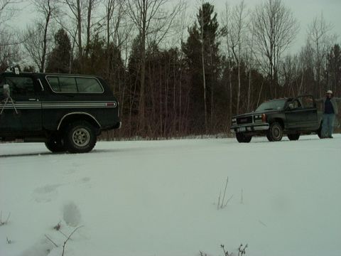 1978 Ford Bronco - A 1978 Ford Bronco is parked in a snowy field next to another vehicle.