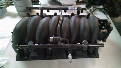 1985 Jeep CJ7 - Intake manifold assembly with fuel rails and injectors, likely from a V8 engine.