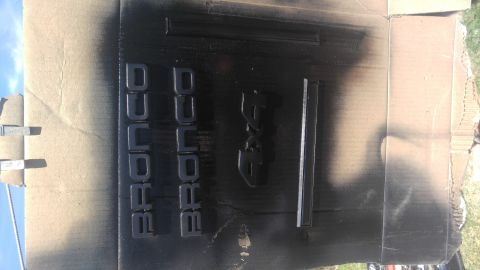 1991 Ford Bronco - Spray painting Ford Bronco emblems and a 4x4 badge for a restoration project.
