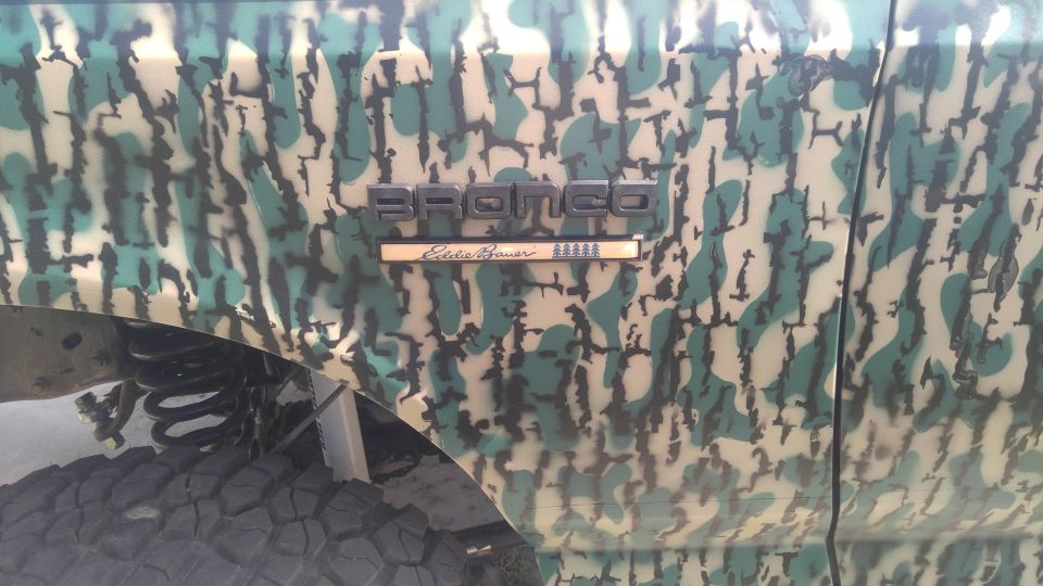 Side view of a Ford Bronco with camouflage paint and an Eddie Bauer badge