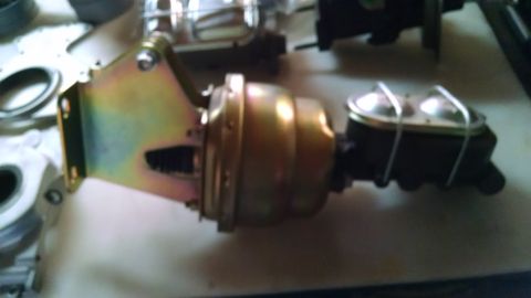 1985 Jeep CJ7 - Brake booster and master cylinder assembly shown on a workbench.