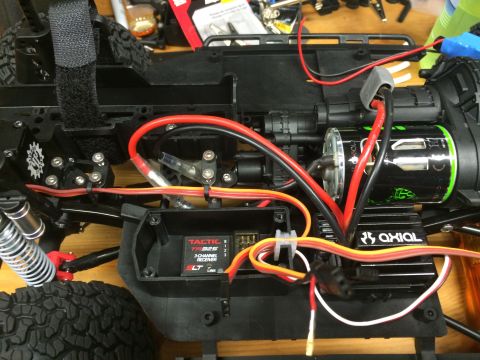 1989 Ford Bronco - Close-up view of an RC car's internal components, including the receiver and motor.