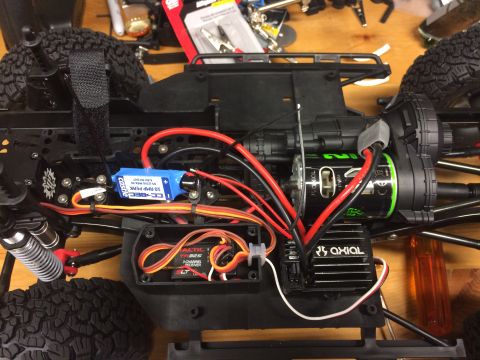 1989 Ford Bronco - Close-up view of the internal electronics and chassis of an RC car, a BEC, motor, and ESC.