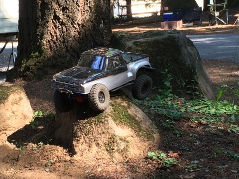 1989 Ford Bronco - RC truck navigates an outdoor obstacle course.