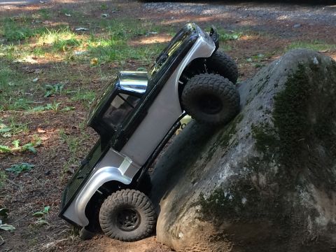 1989 Ford Bronco - This remote control truck is navigating a challenging rocky terrain.