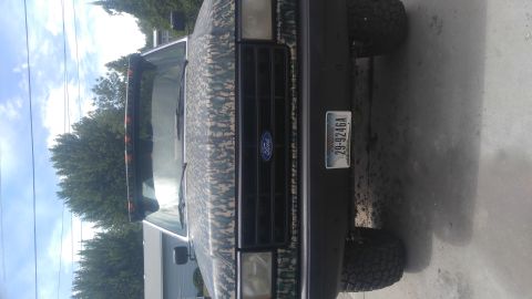 1991 Ford Bronco - This 1991 Ford Bronco is covered in a camouflage wrap and is shown from the front.