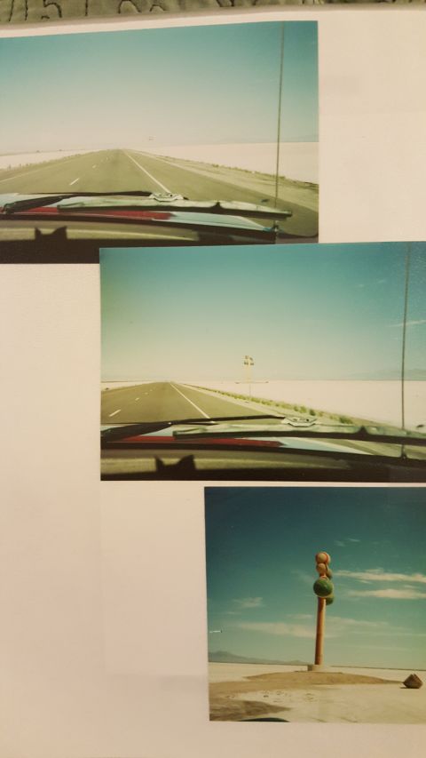 1996 Ford Bronco - View from inside a vehicle looking out at a desolate highway, possibly the Bonneville Salt Flats.