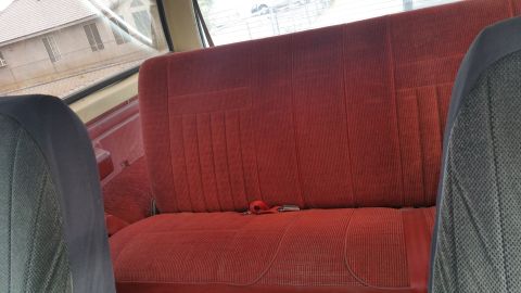 1988 Ford Bronco - Interior view of red seats, likely from a vehicle.