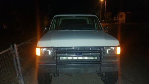 1988 Ford Bronco - This 1988 Ford Bronco is seen at night with its headlights and front turn signals illuminated.